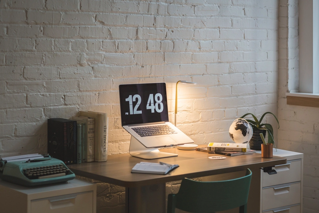 Bright modern office workspace with desks and laptops